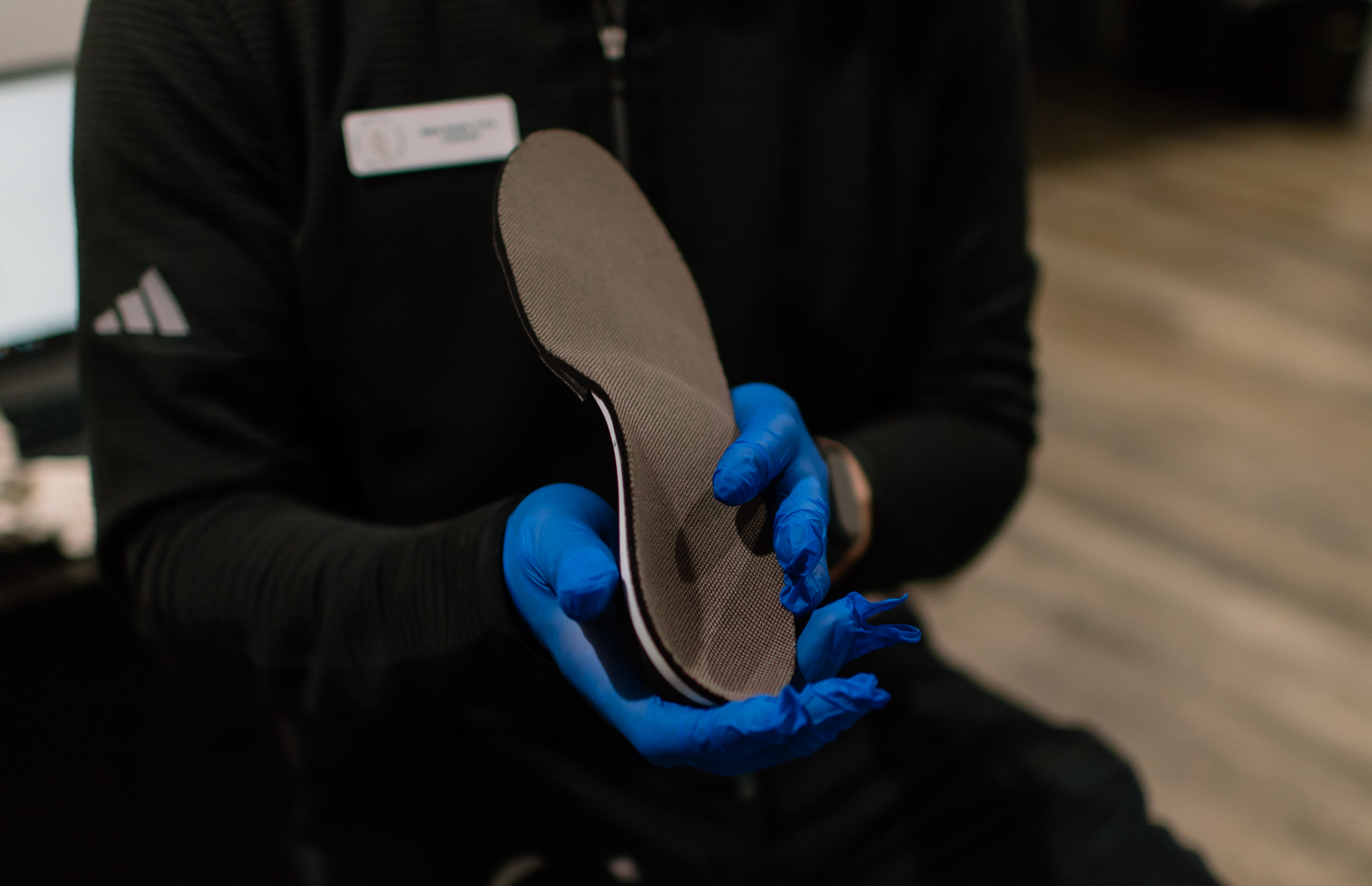 Chiropodist showing patient an orthotic at The Foot Health Centre